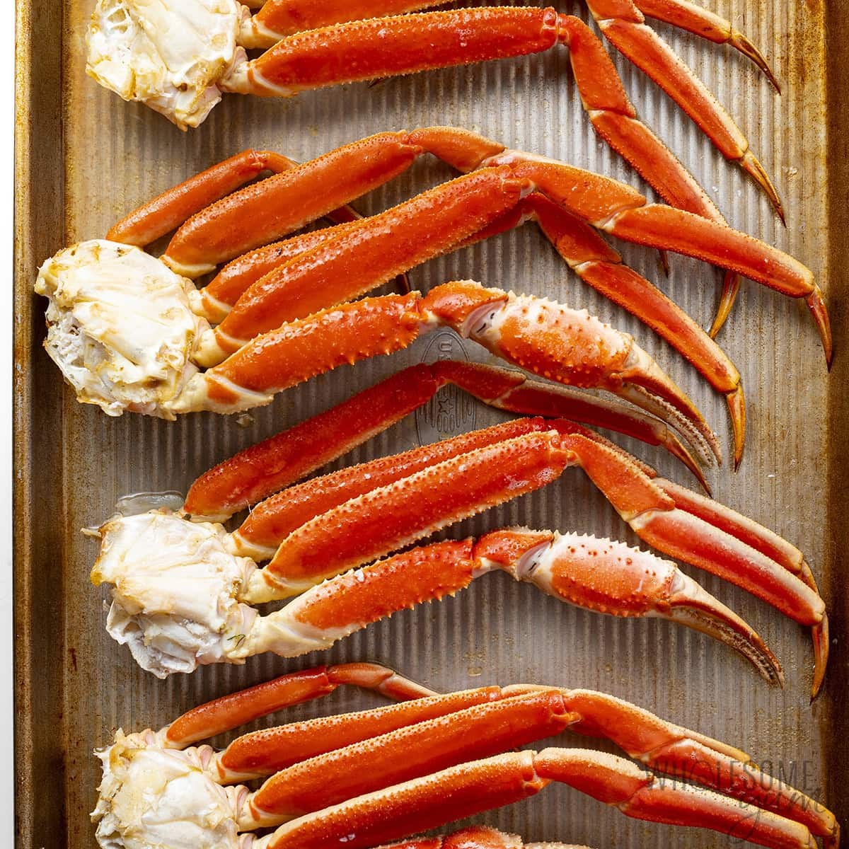 Baked crab legs on a sheet pan.