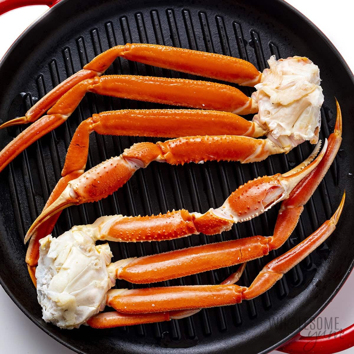 Grilled crab legs on a grill pan.