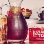 Refreshing pitcher of Luzianne iced tea served in glasses, perfect for family gatherings.