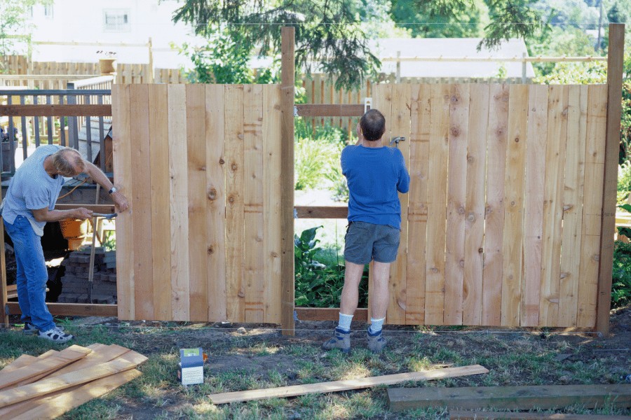 Couple building a fence together