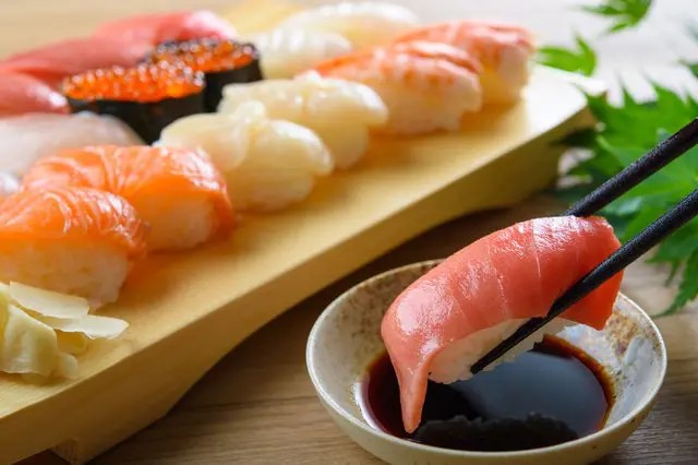 A selection of fresh sushi, ranging from affordable conveyor belt options to luxurious high-end dining experiences.