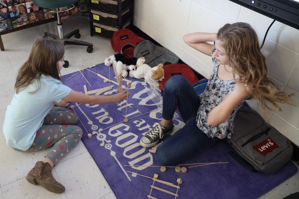 Students playing with STEM kits, with their Battle Pups and new book bags, the first day back after Helene