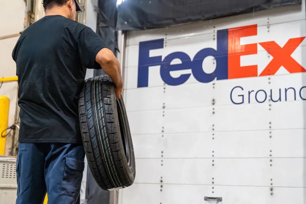 A delivery truck delivering tires to a customer's home, highlighting the convenience of tire delivery services.