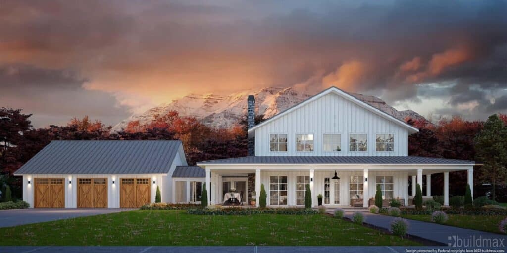 Exterior of a white barndominium, complete with a three-car garage and a wraparound porch, set against a scenic mountain backdrop