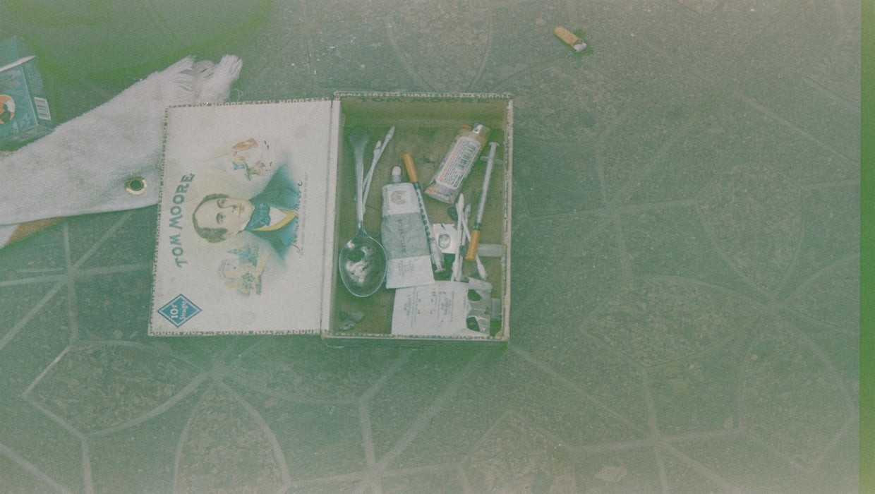 This police photo shows Cobain's heroin kit complete with syringes and other paraphernalia kept in a cigar box.