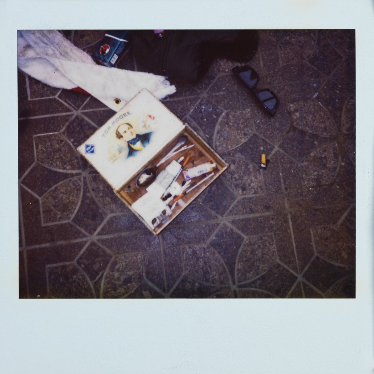 This police photo shows Cobain's heroin kit complete with syringes and other paraphernalia kept in a cigar box.