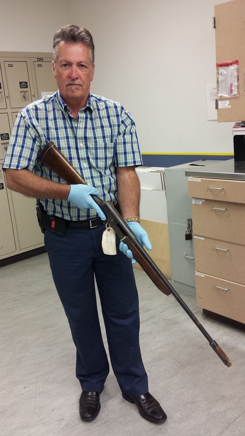 This photograph, released on March 17, 2016, shows Seattle Police cold case Detective Michael Ciesynski holding the shotgun police say Kurt Cobain used to kill himself. The shotgun hadn't been seen before publicly, except for certain crime scene photos that reveal a partial view of the weapon.