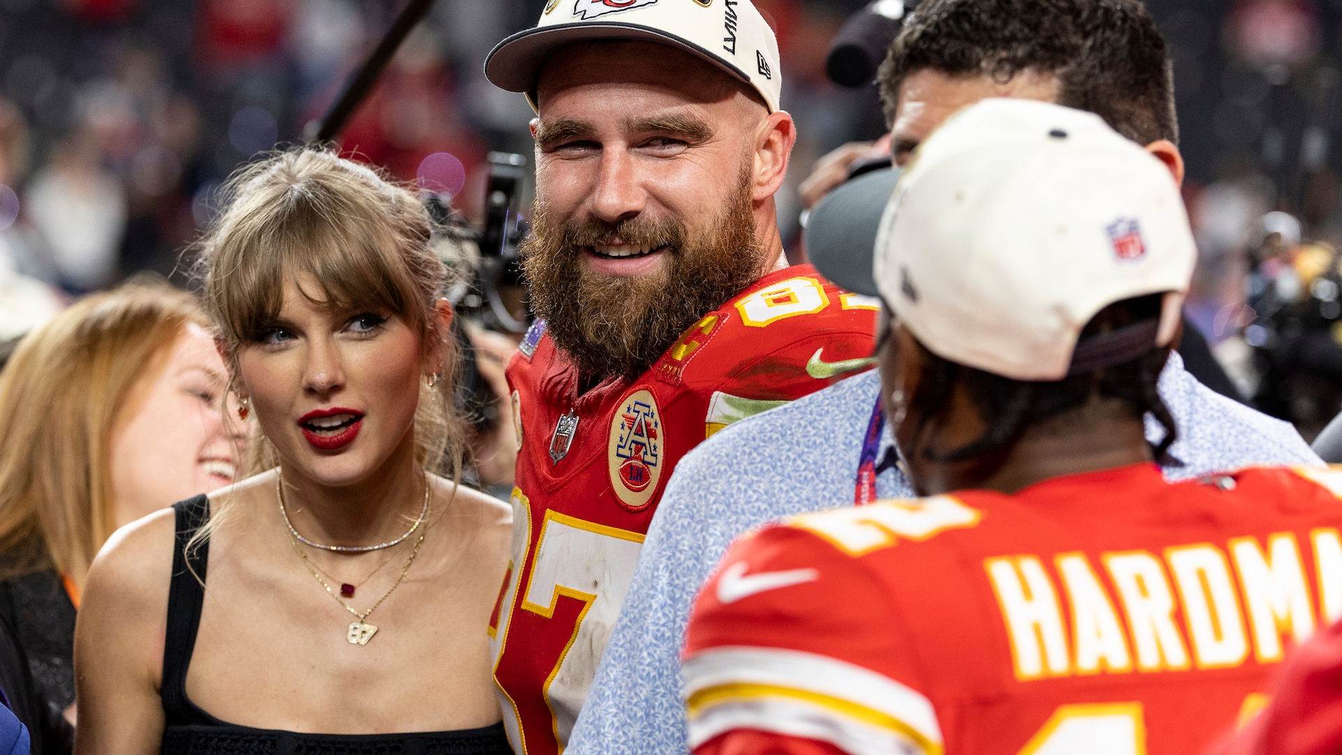 Taylor Swift and Travis Kelce embracing after a Chiefs game