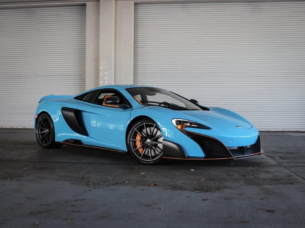 A sky blue McLaren 650s with orange trim showcasing the car's luxurious and sleek design