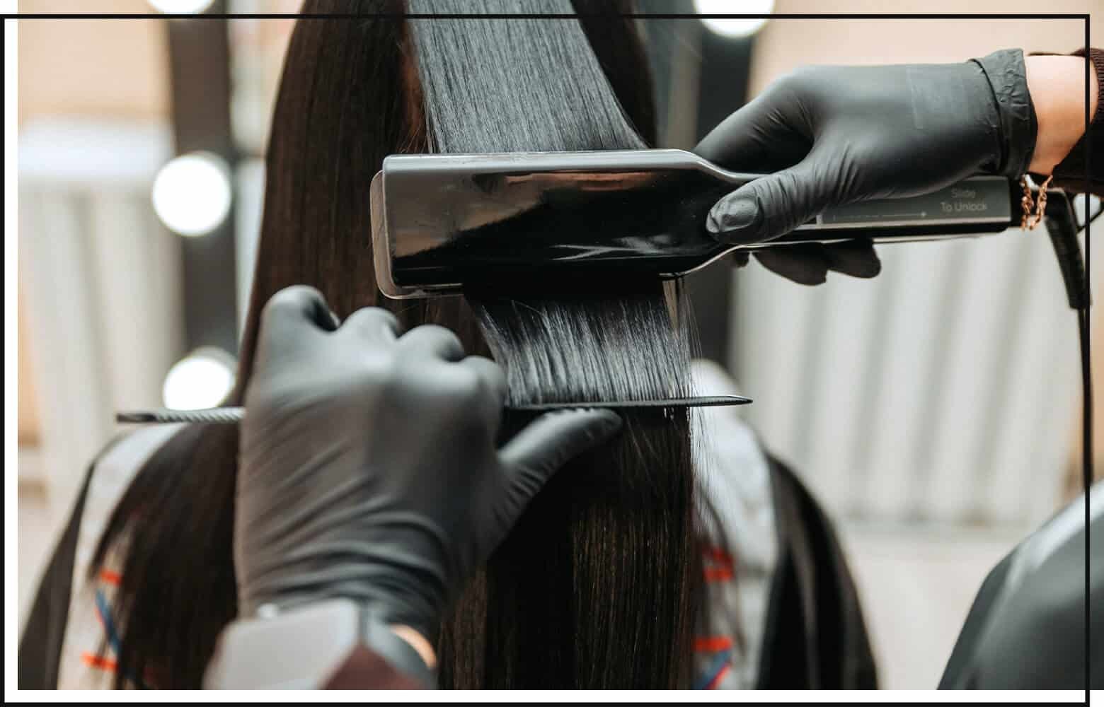 stylist flat ironing and combing client