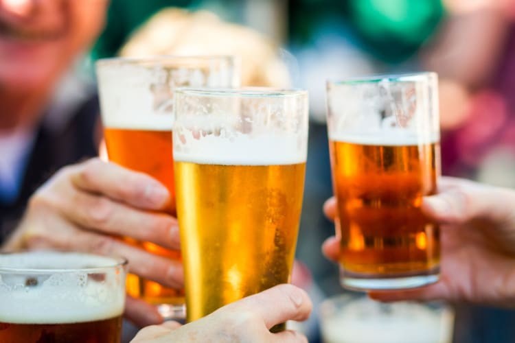 Pints of beer being toasted