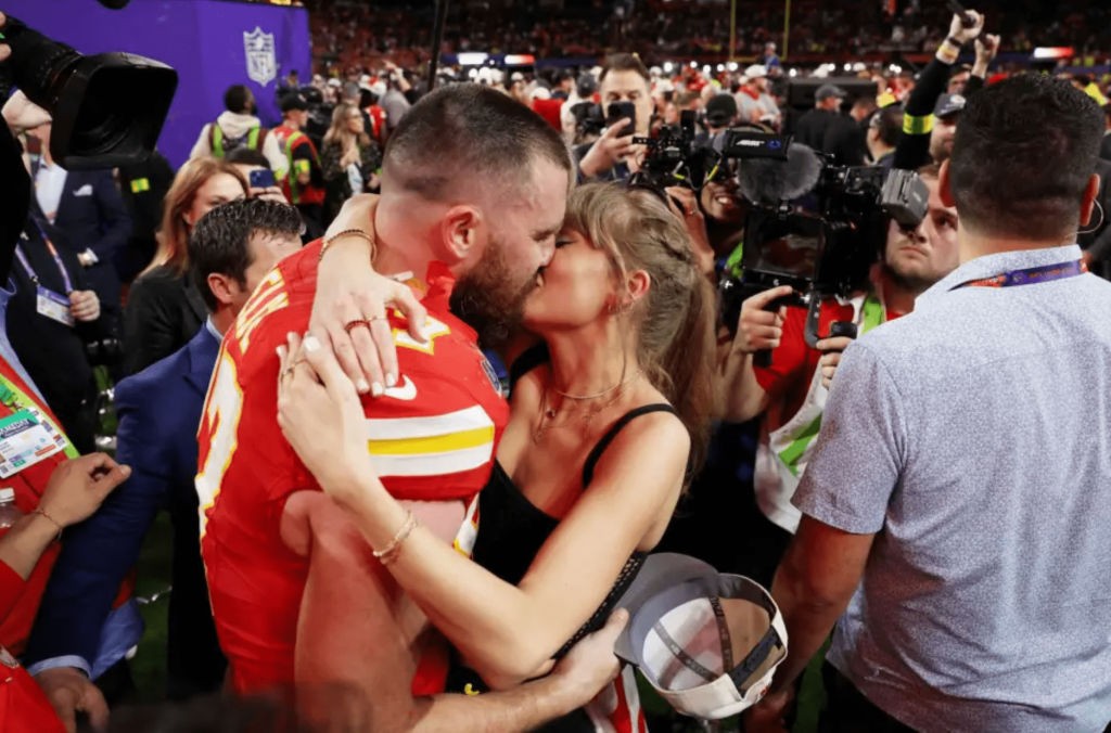 Taylor Swift and Travis Kelce sharing a kiss after the Super Bowl