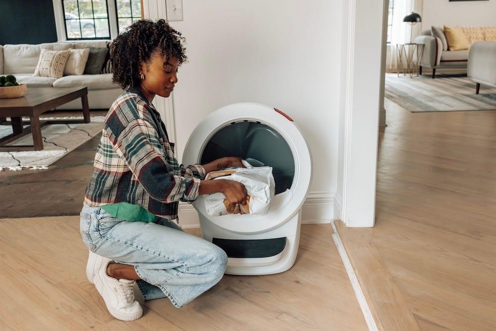 Woman Adding Cat Litter to Litter-Robot