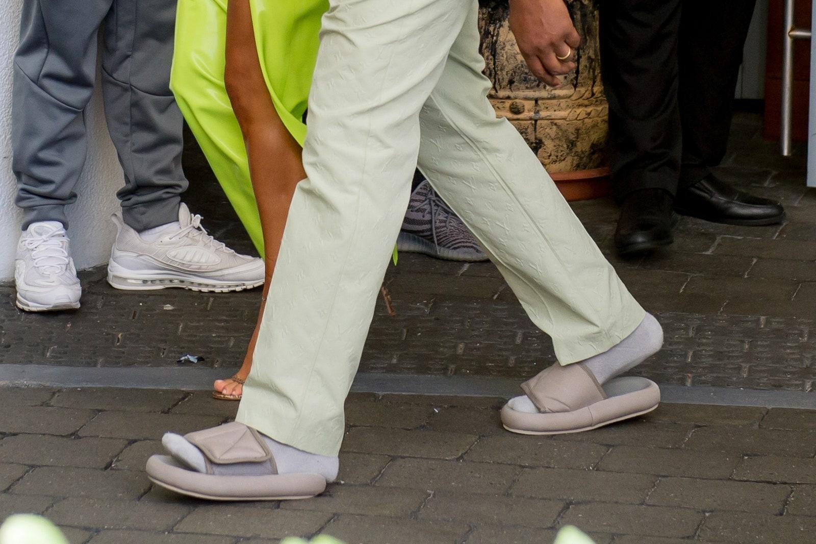 Kanye West wearing Yeezy Slides