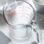 Close-up of a kitchen scale displaying grams and ounces.