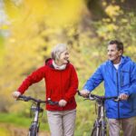 Active seniors walking with bike