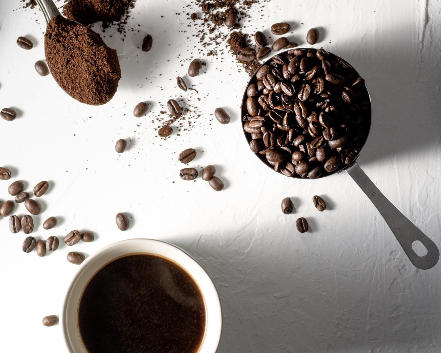 Espresso shot next to coffee beans