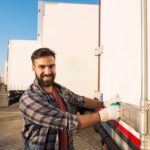 Smiling truck driver working gloves