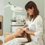 Esthetician providing facial treatment