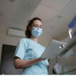 LPN using stethoscope examines patient