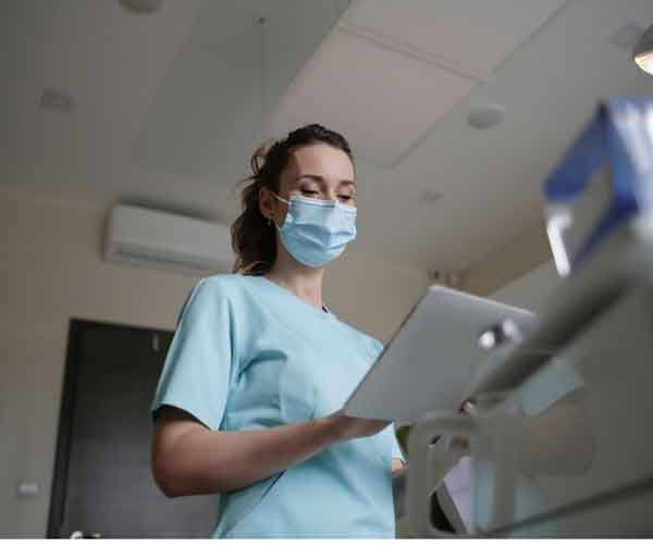 LPN using stethoscope examines patient