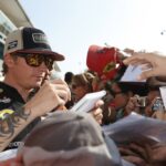 Kimi Raikkonen signs autographs for fans at Monza in September 2012.