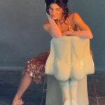 Kylie Jenner shared behind-the-scenes outtakes from her British Vogue cover shoot, showcasing a candid moment with her children