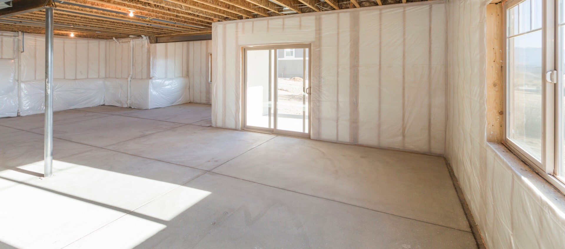 Unfinished basement with doors to the outside