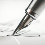 Man writing letter on desk