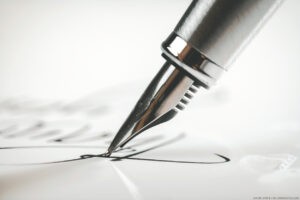 Man writing letter on desk