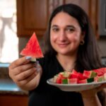 Diced watermelon in a measuring cup showing its volume, used to illustrate the sugar comparison with other fruits