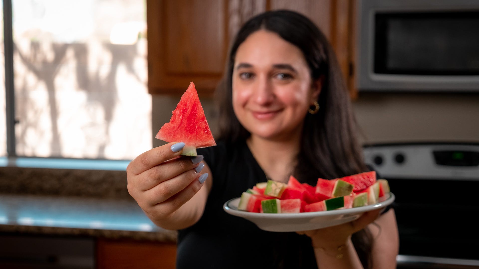 Diced watermelon in a measuring cup showing its volume, used to illustrate the sugar comparison with other fruits