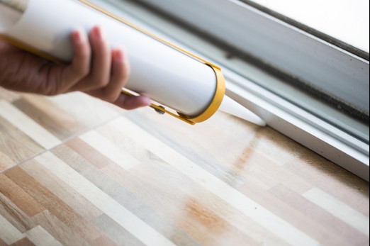 Sealing Up Window to Keep Box Elder Bugs from Entering Home