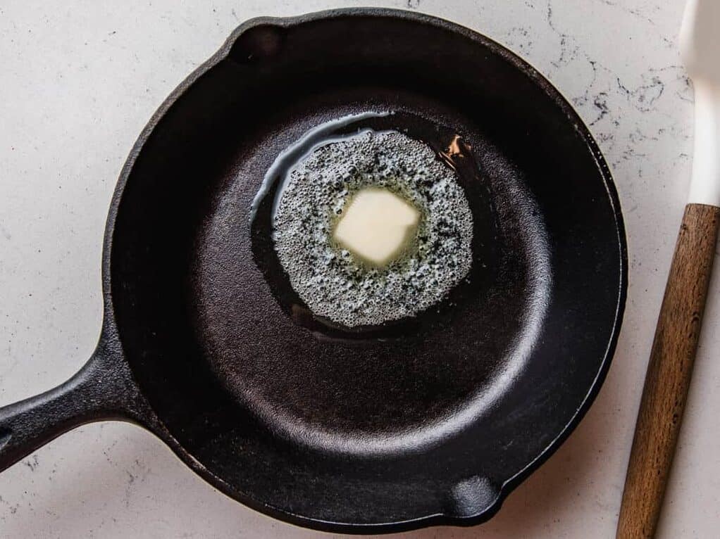 Butter melting in a cast iron pan