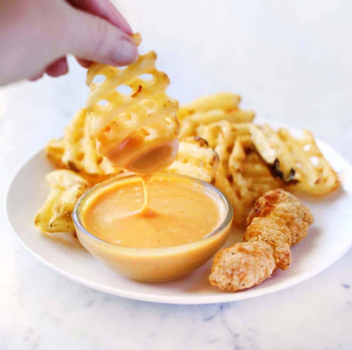 Ingredients for making Chick-fil-A sauce including mayonnaise, mustard, BBQ sauce, and honey