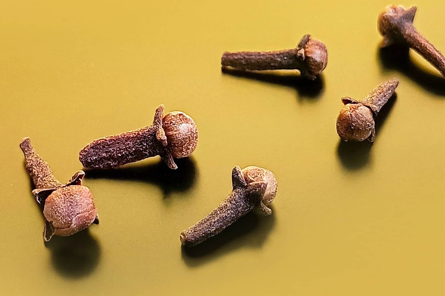 A pile of aromatic cloves used for flavoring chai latte