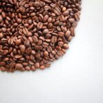 Coffee beans on the white background in an arc