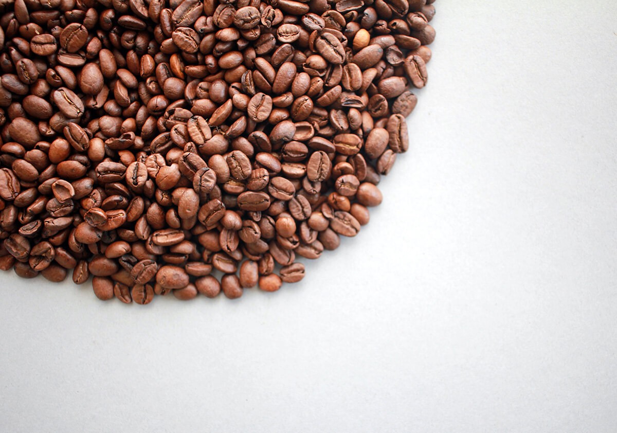 Coffee beans on the white background in an arc
