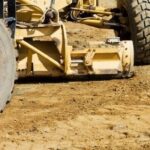 Grading cost depends on amount of dirt to be moved, tractor and operator rates apply