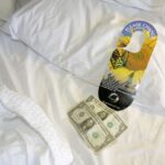 A housekeeping tip left on a hotel bed.