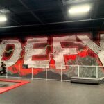 Boy doing a trick on a trampoline in DEFY