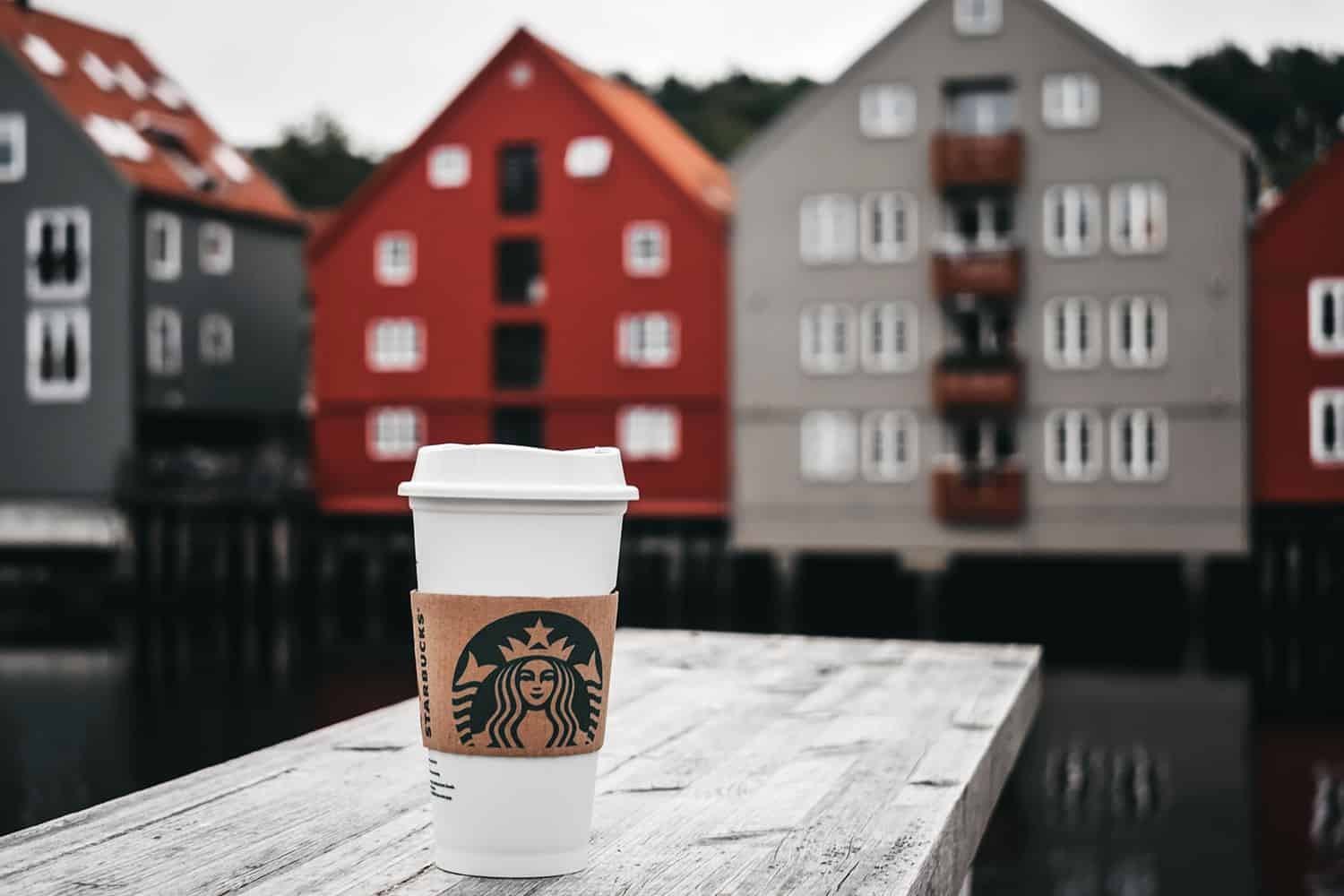 A cup of Starbucks chai latte on a wooden surface