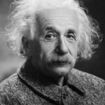Albert Einstein, symbol of intellectual genius, in a black and white portrait.