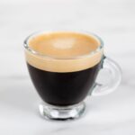 Well balanced cup of espresso indicating how much caffeine is in a shot of espresso