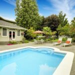 Backyard inground vinyl pool with patio and lounge area