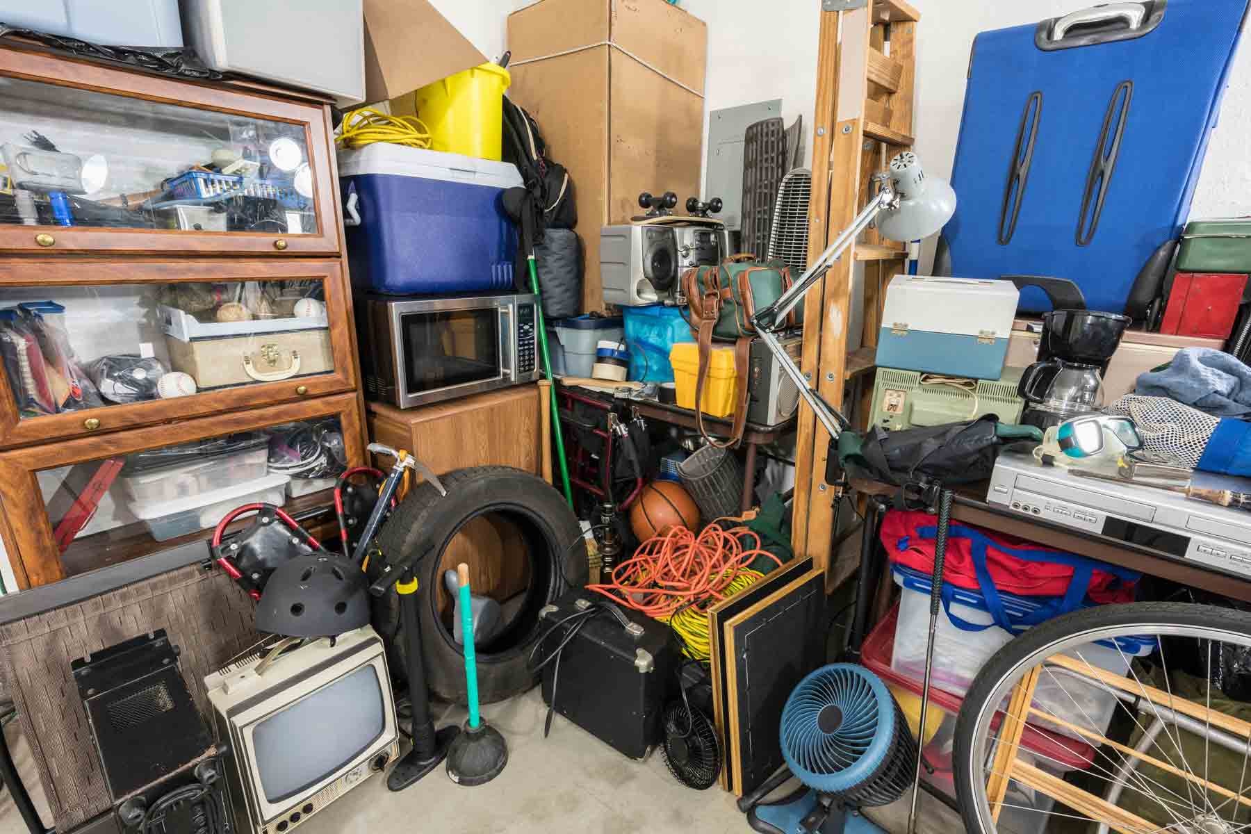 A garage full of junk and old items awaiting pickup by a junk removal company