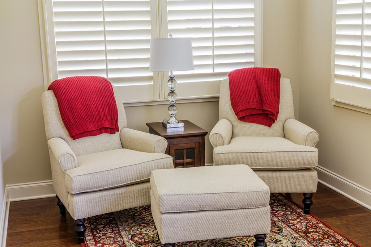 Sunroom with real wood plantation shutters and lounge furniture