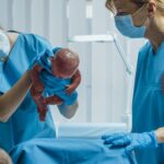 Labor and Delivery Nurse Assisting Mother