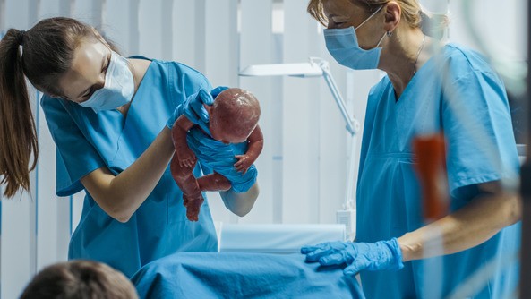 Labor and Delivery Nurse Assisting Mother