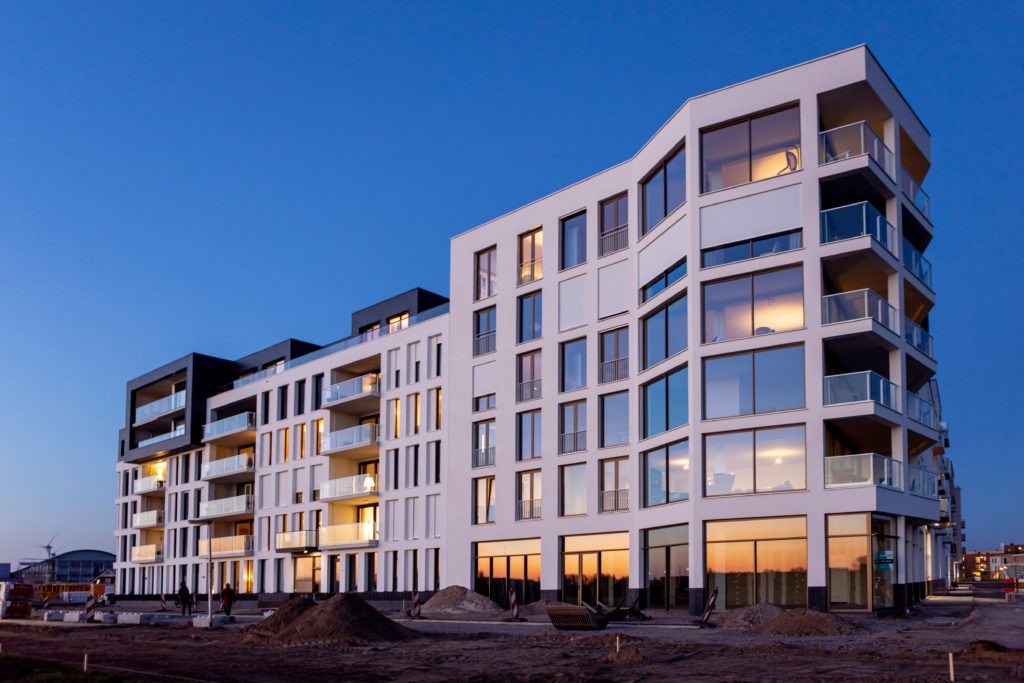 Apartment complex under construction with construction workers; zoning permit